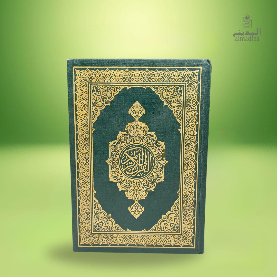 Holy Quran Saudi book with gold patterns on a green background